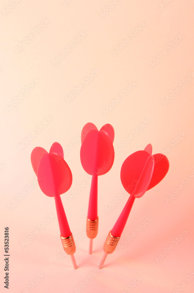 Darts on pink background Darts on pink background