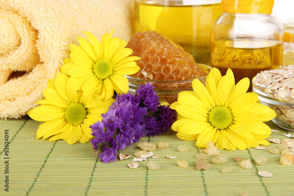 Fragrant honey spa with oils and honey on wooden table close-up Fragrant honey spa with oils and honey on wooden table close-up