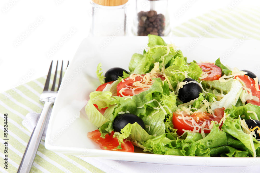 Light salad on plate on napkin Light salad on plate on napkin