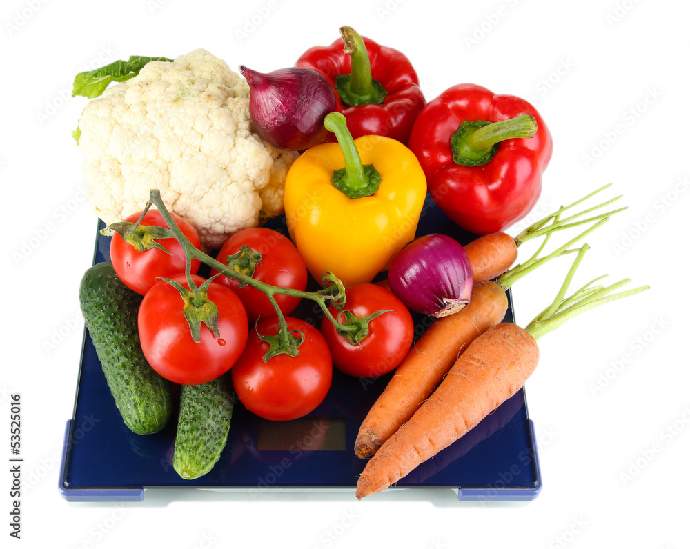Fresh vegetables on scales on grey background Fresh vegetables on scales on grey background