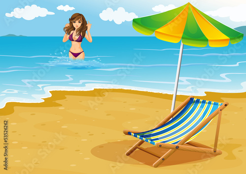 A beach with a lady in a purple bikini