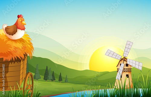 A farm with a barnhouse and a windmill