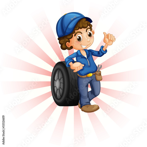 A boy in front of a wheel with a blue cap