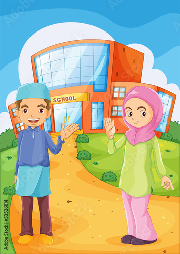 A male and a female Muslim in front of a school building