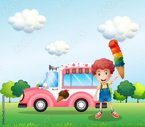 A boy holding a cone with multiple layers of ice cream