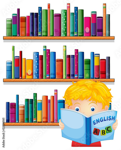 A boy reading with a wooden shelves at the back