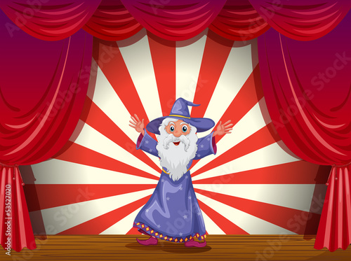 A wizard in the middle of the stage with a red curtain