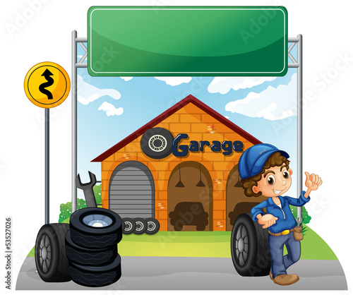 A boy standing beside a wheel outside the garage