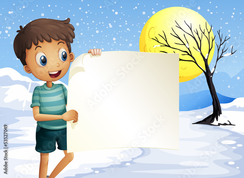 A boy smiling holding an empty signage