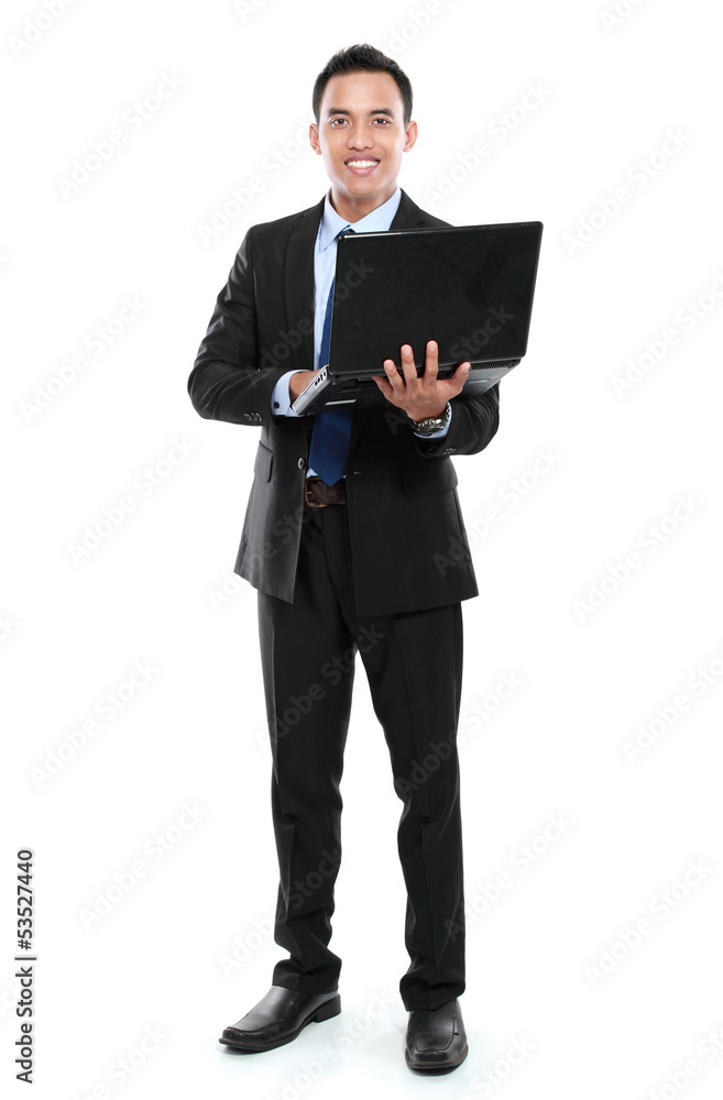 Business man with laptop looking at camera Business man with laptop looking at camera