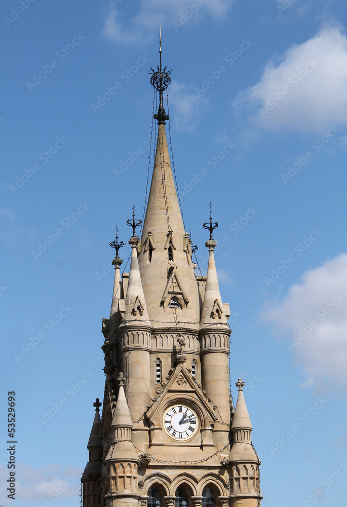 A Stone Clock Tower on a Classic Urban Building.