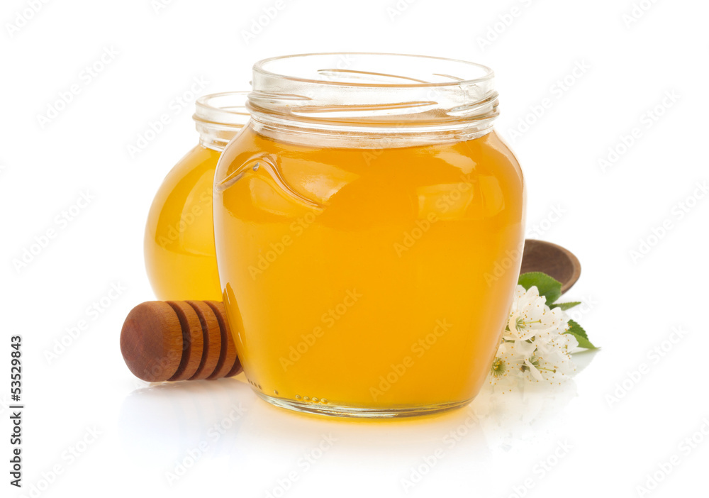 glass jar full of honey and stick glass jar full of honey and stick