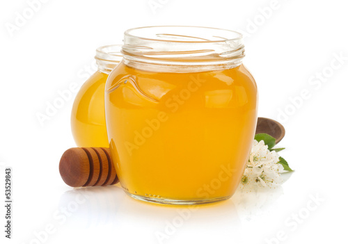 glass jar full of honey and stick