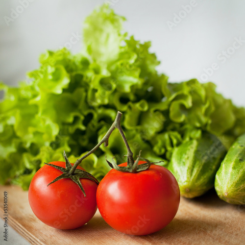 tasty tomatoes, cucumbers and salad on the kitchen