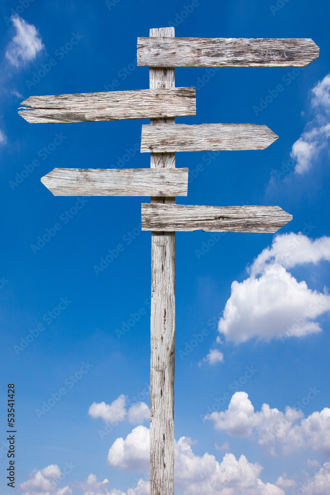 Old wood sign against blue sky background Old wood sign against blue sky background