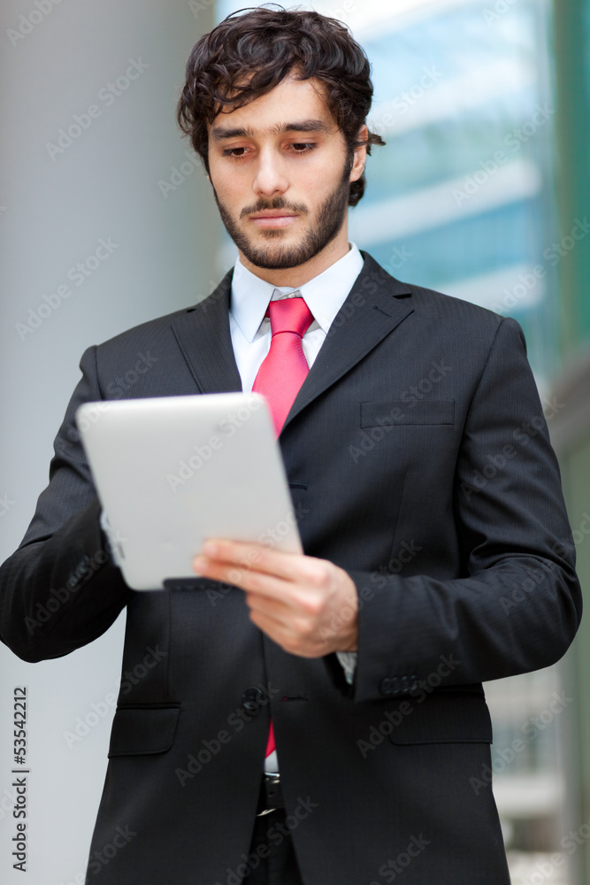 Portrait of a young business man holding his tablet Portrait of a young business man holding his tablet