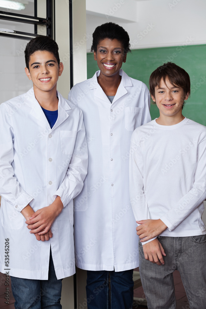 Teacher With Male Students Standing Together In Science Lab Teacher With Male Students Standing Together In Science Lab