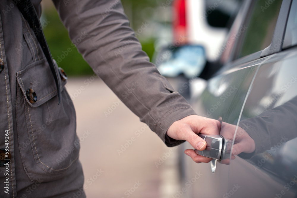 Female hand opening a car door