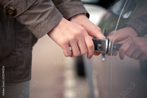 Woman unlocking her car with a key