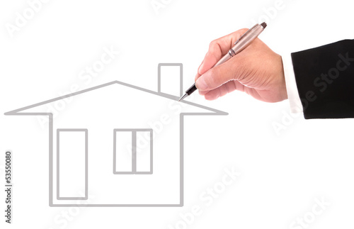 hand of business man writing new home out line on white
