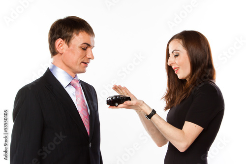 young man and woman are holding a toy car