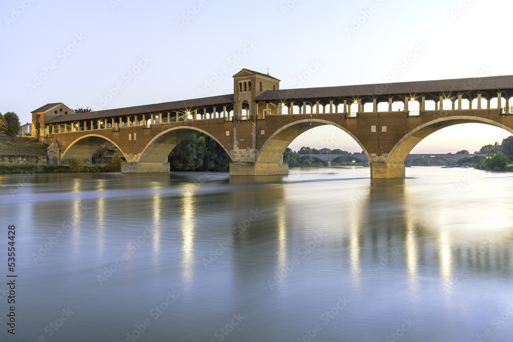 Fototapeta premium Pavia- covered bridge on Ticino river night view color image