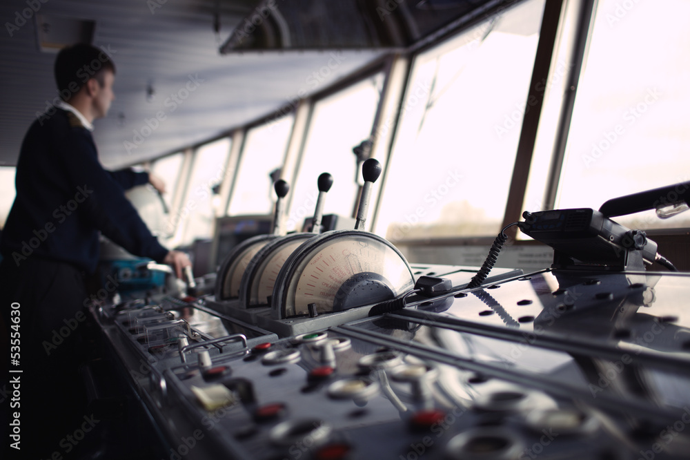 Navigation officer driving ship on the river. Stock-Foto | Adobe Stock