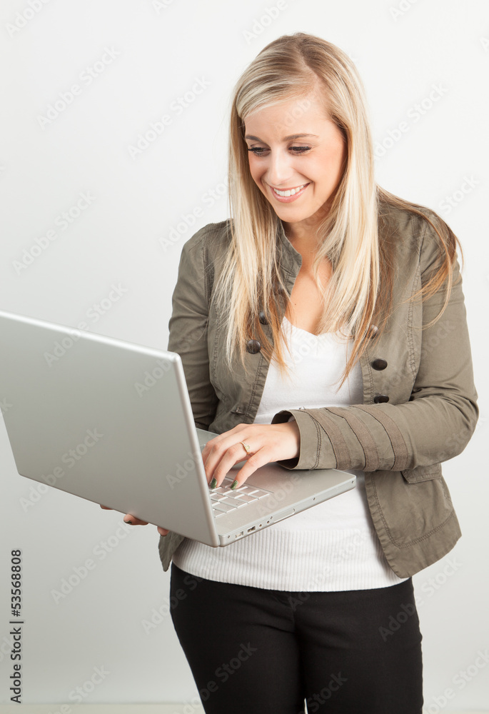 Portrait of a young blond woman smiling wiith a laptop Portrait of a young blond woman smiling wiith a laptop