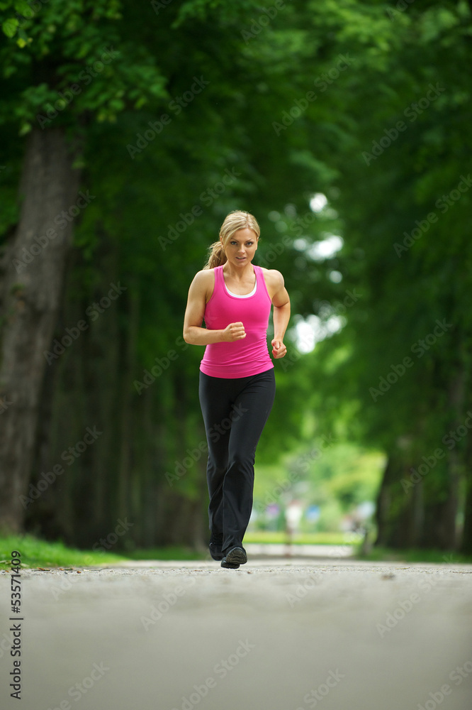 Active young woman jogging in the park