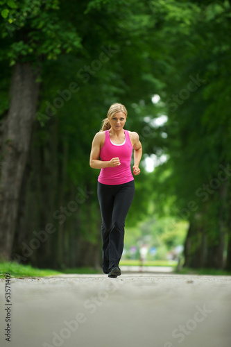 Active young woman jogging in the park
