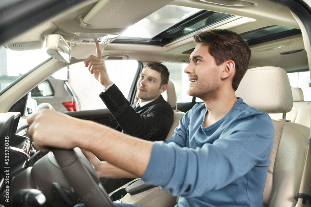 This model comes with added features. Handsome young salesman sh This model comes with added features. Handsome young salesman sh