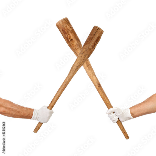 Foto Two hands holding cudgels crossed