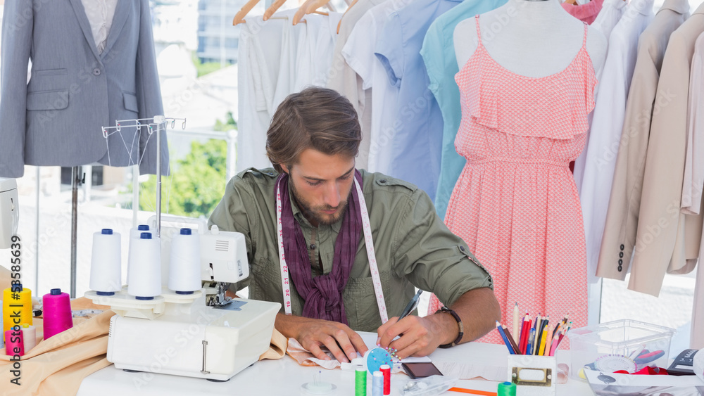 Fashion designer drawing on a desk Fashion designer drawing on a desk