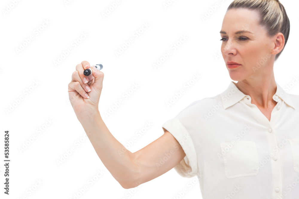 Serious businesswoman looking at pen in her hand Serious businesswoman looking at pen in her hand