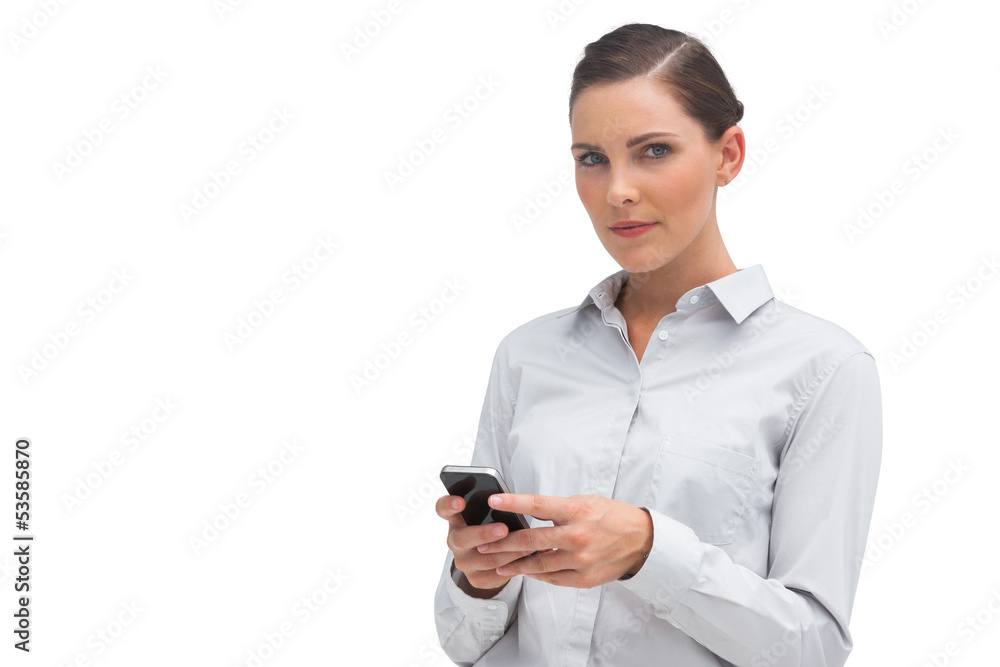 Unsmiling businesswoman holding cellphone Unsmiling businesswoman holding cellphone