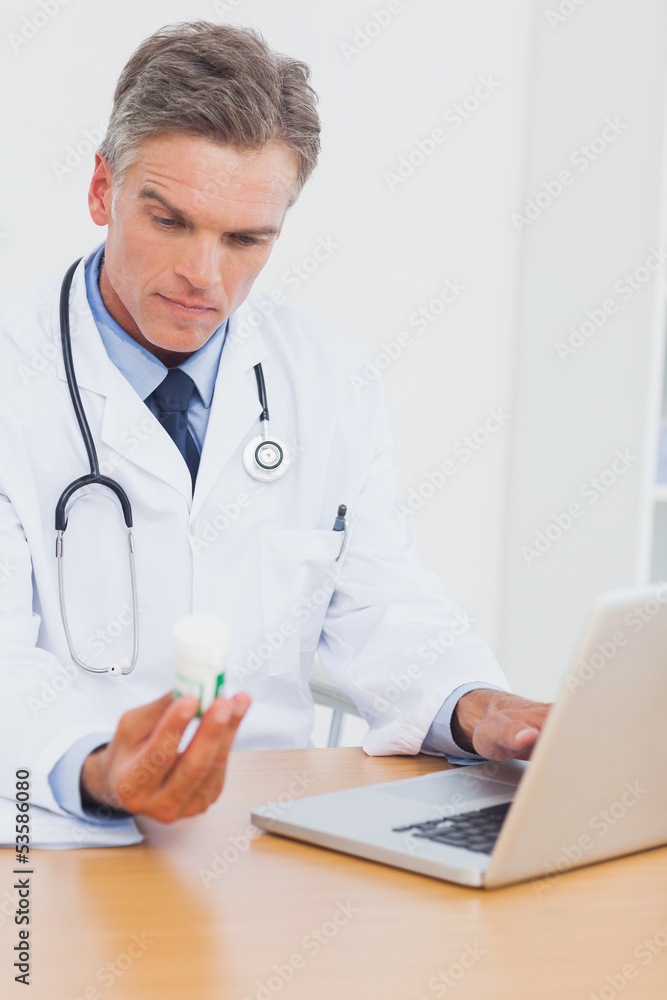 Doctor holding a bottle of pills Doctor holding a bottle of pills