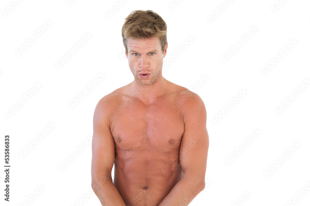 Handsome shirtless man showing his muscles