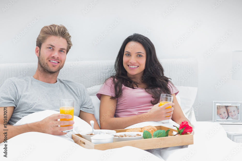 Couple having breakfast in bed Couple having breakfast in bed