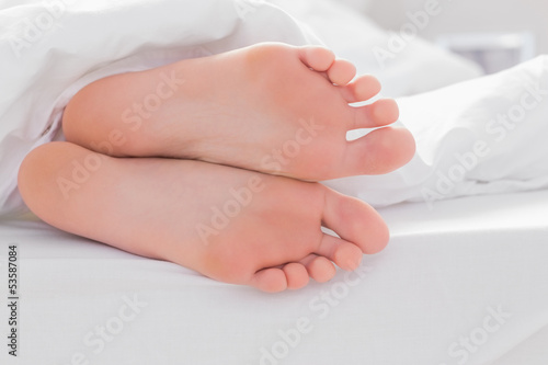 Feet under a quilt