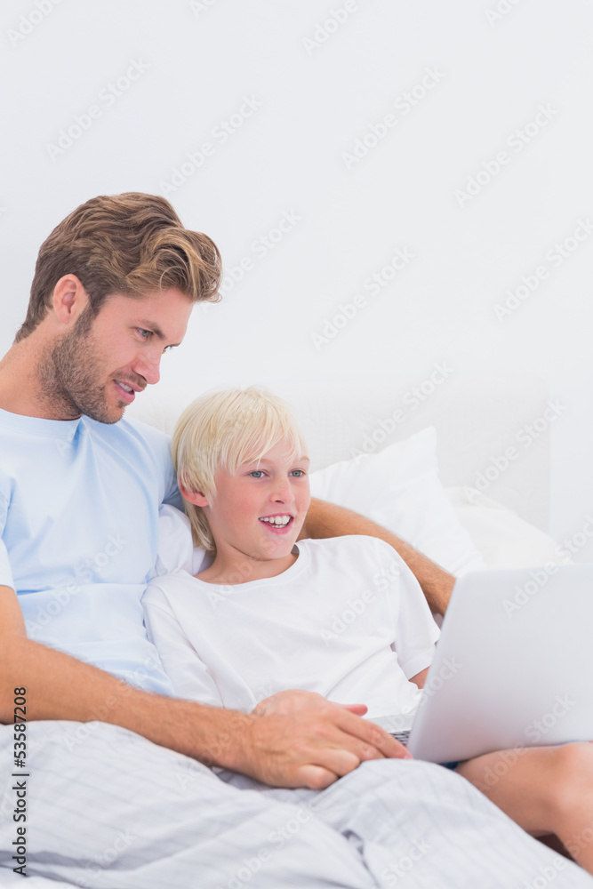 Father and his son using a laptop Father and his son using a laptop