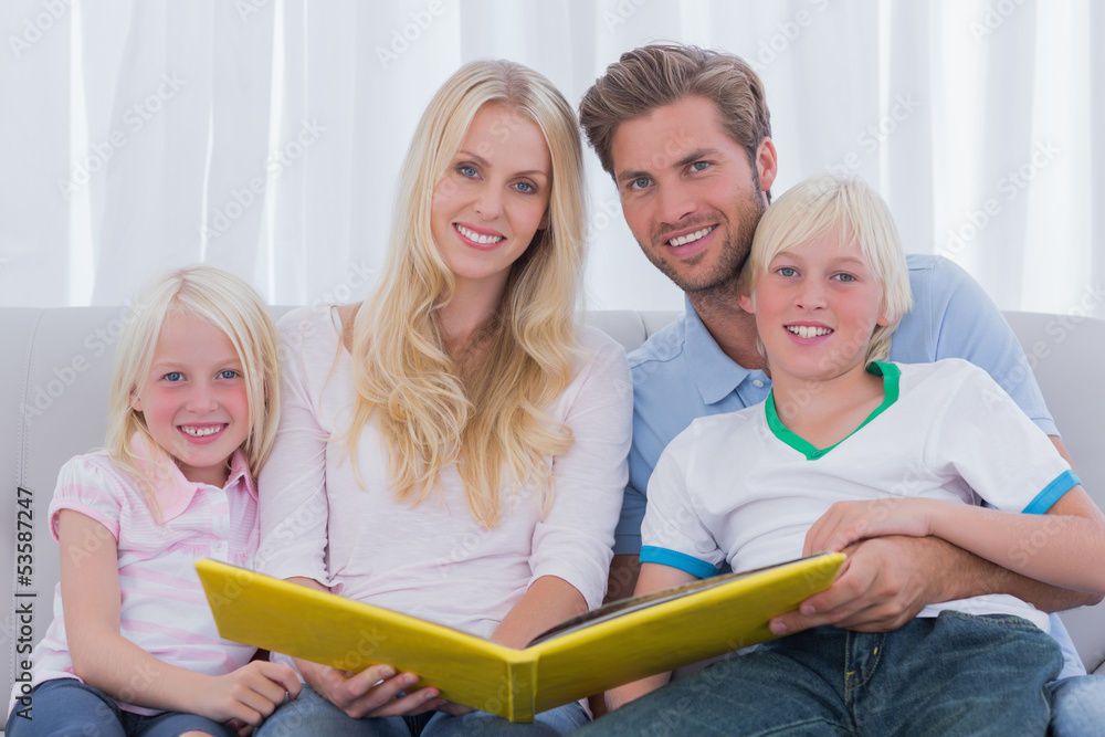 Portrait of a family holding a story book Portrait of a family holding a story book