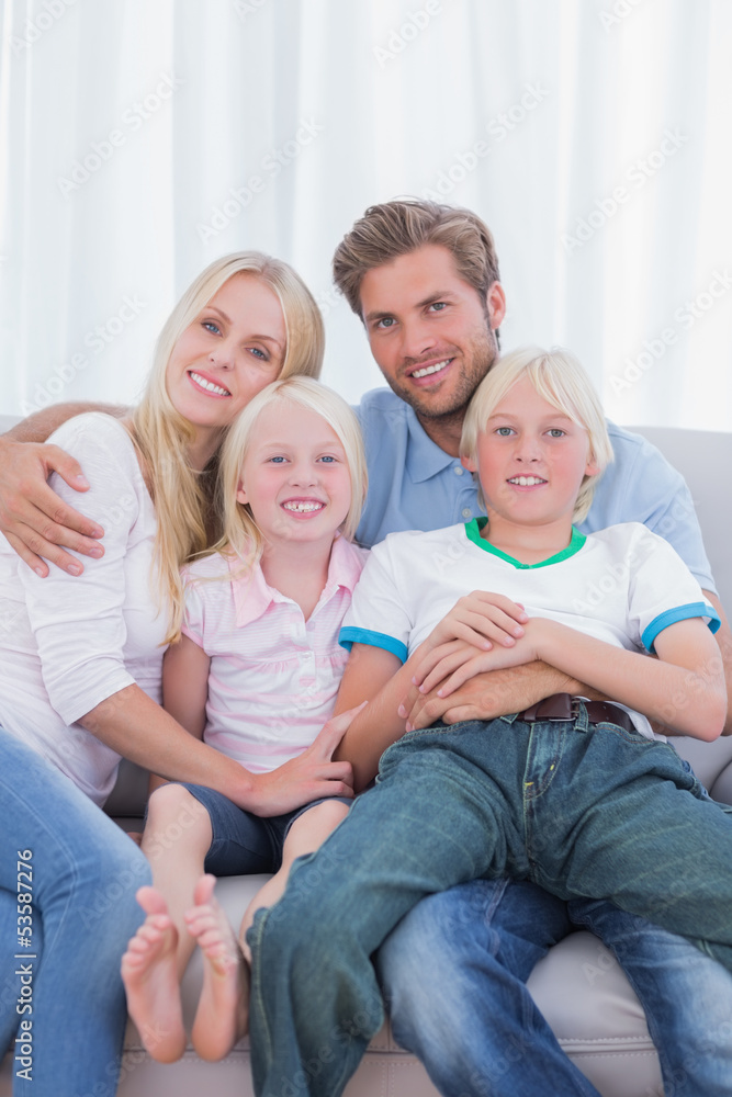 Parents and children sitting together on couch Parents and children sitting together on couch