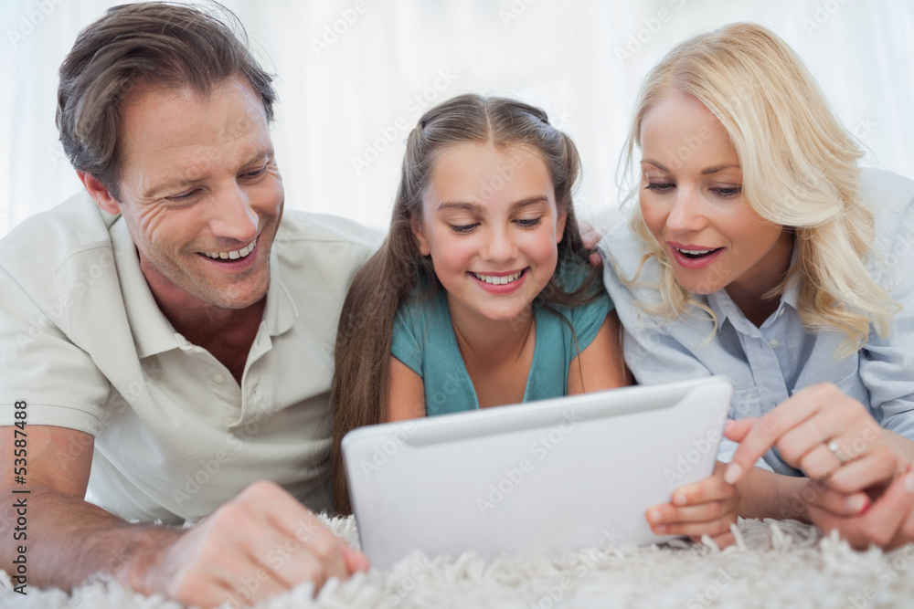Girl and her parents using a tablet Girl and her parents using a tablet