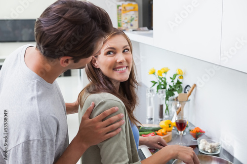 Delighted couple cooking in kitchen