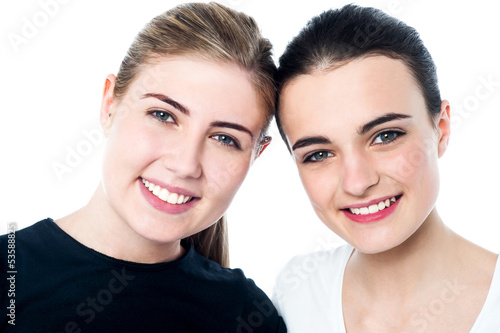 Young smiling girls looking at you
