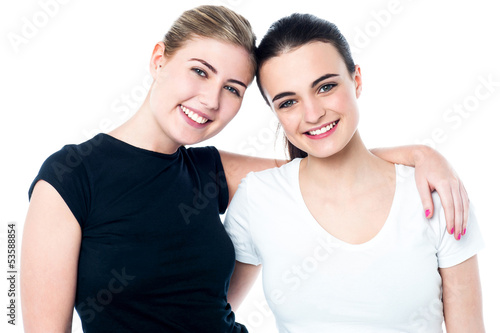 Two teenage friends smiling in front of camera