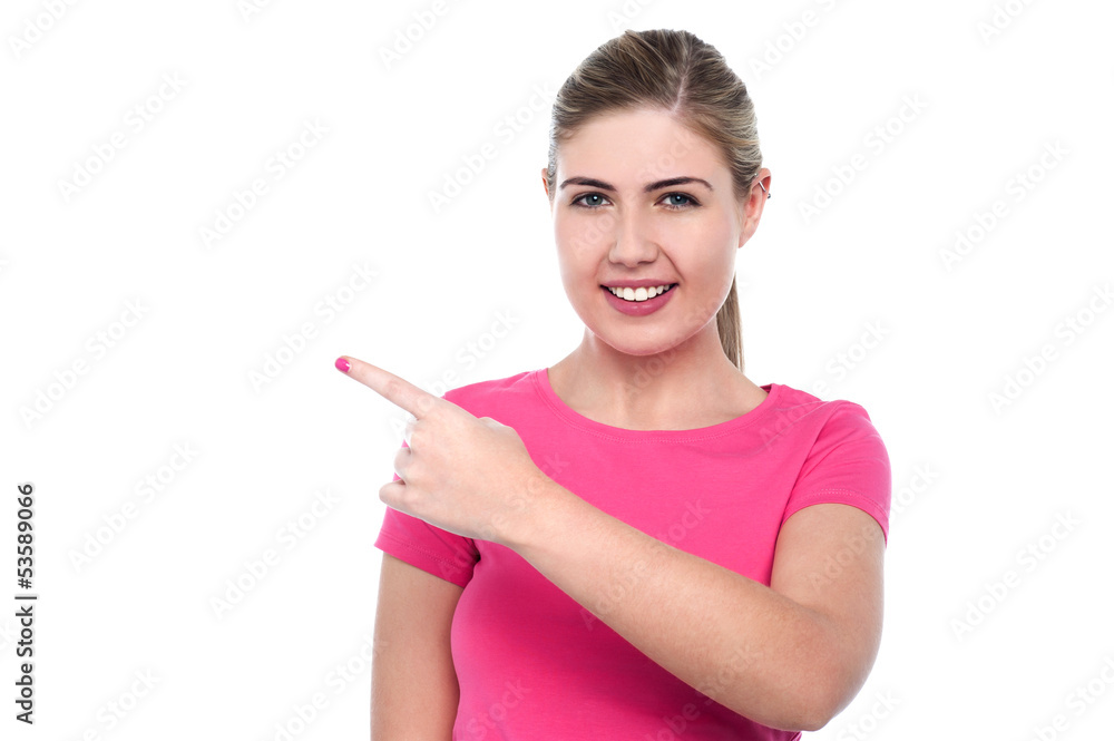 Smiling young girl pointing away Smiling young girl pointing away