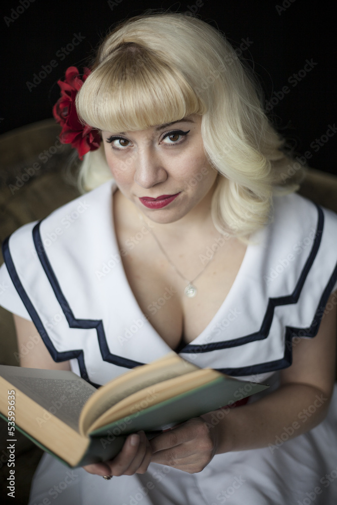 Beautiful Young Woman with Blond Hair Reading Book