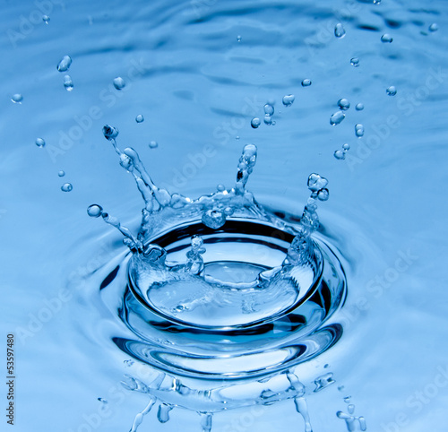 Splash water over blue background. Nature, object.