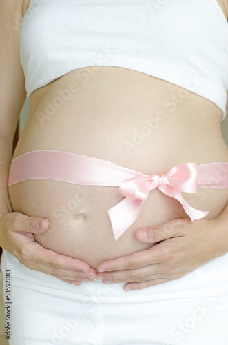 Wallpaper Mural Pregnant woman with a pink ribbon holding with both hands Torontodigital.ca